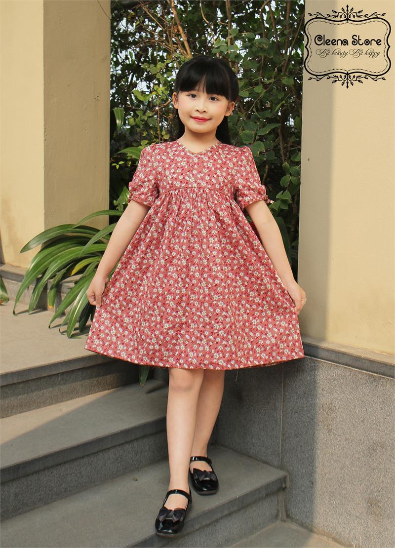 Đầm xòe hạ eo cao cổ tim tay thắt nơ hoa trắng nền hồng